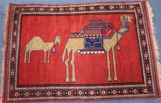 A Persian rug, decorated with camels, 4ft 9in. x 3ft 2in.